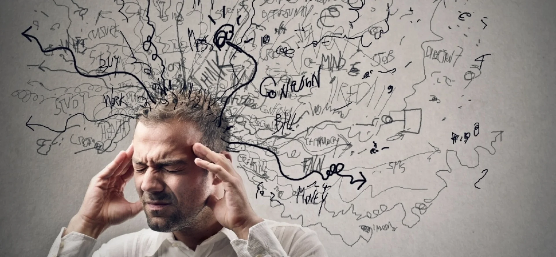 Man holding head with chaotic scribbles representing racing thoughts