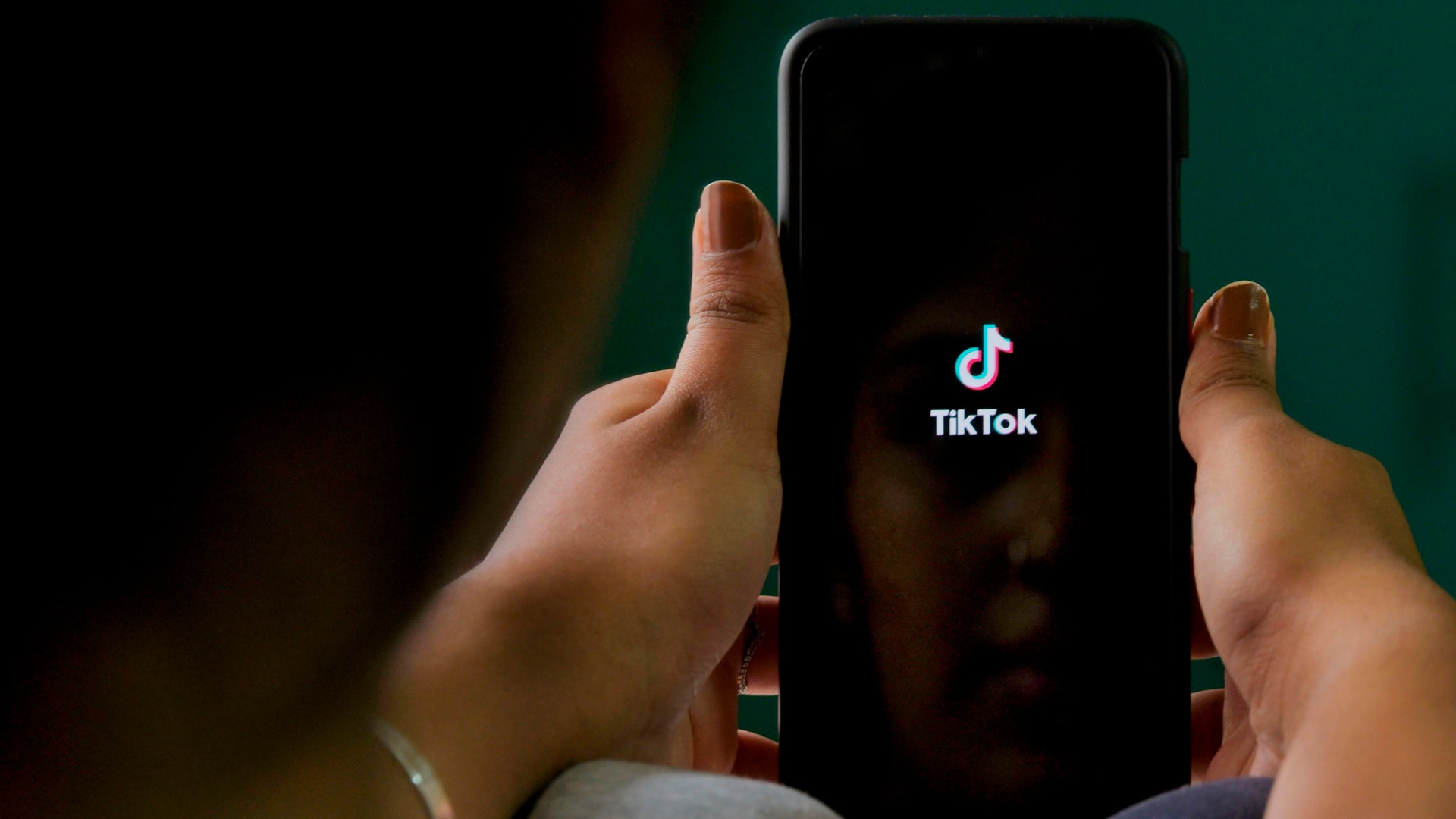 A mobile user browses through the Chinese-owned TikTok app on a smartphone in Bangalore, India. TikTok on June 30 denied sharing information on Indian users with the Chinese government, after New Delhi banned the wildly popular app, citing national security and privacy concerns. 