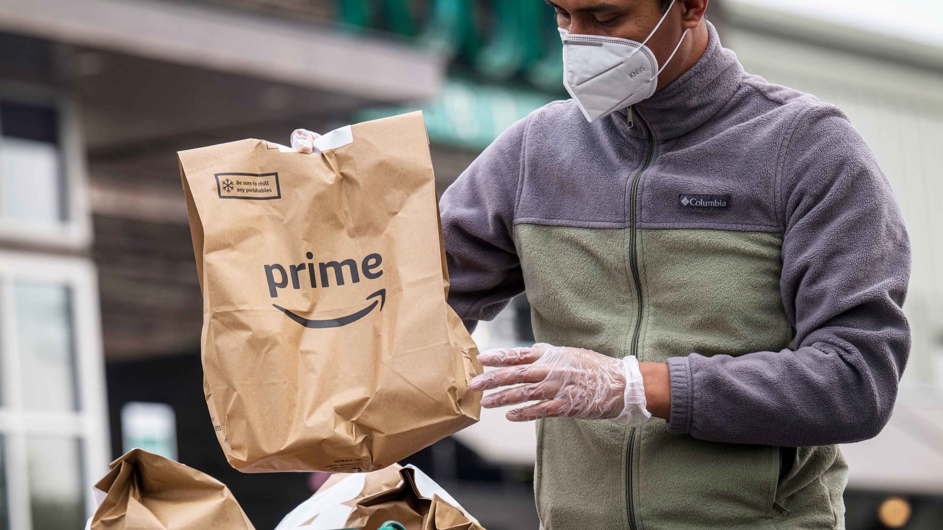 An independent contractor loads Amazon Prime grocery bags into a car outside a Whole Foods Market in Berkeley, California.