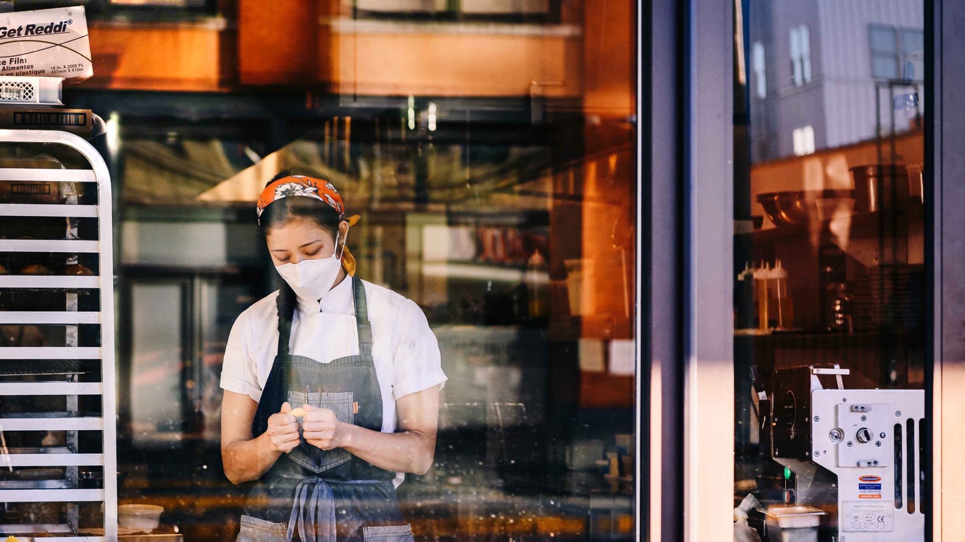 A worker wears a protective mask while preparing food at a restaurant in downtown Memphis.