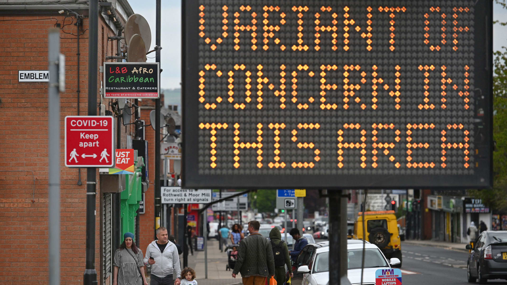 A public health digital board warns the public of a Covid variant in Bolton, England.