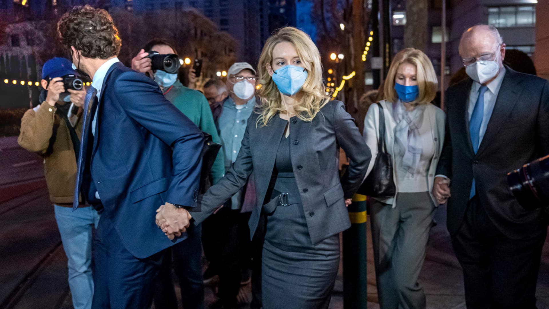 Elizabeth Holmes, left center, departs from federal court with her family on Monday, January 3rd. 