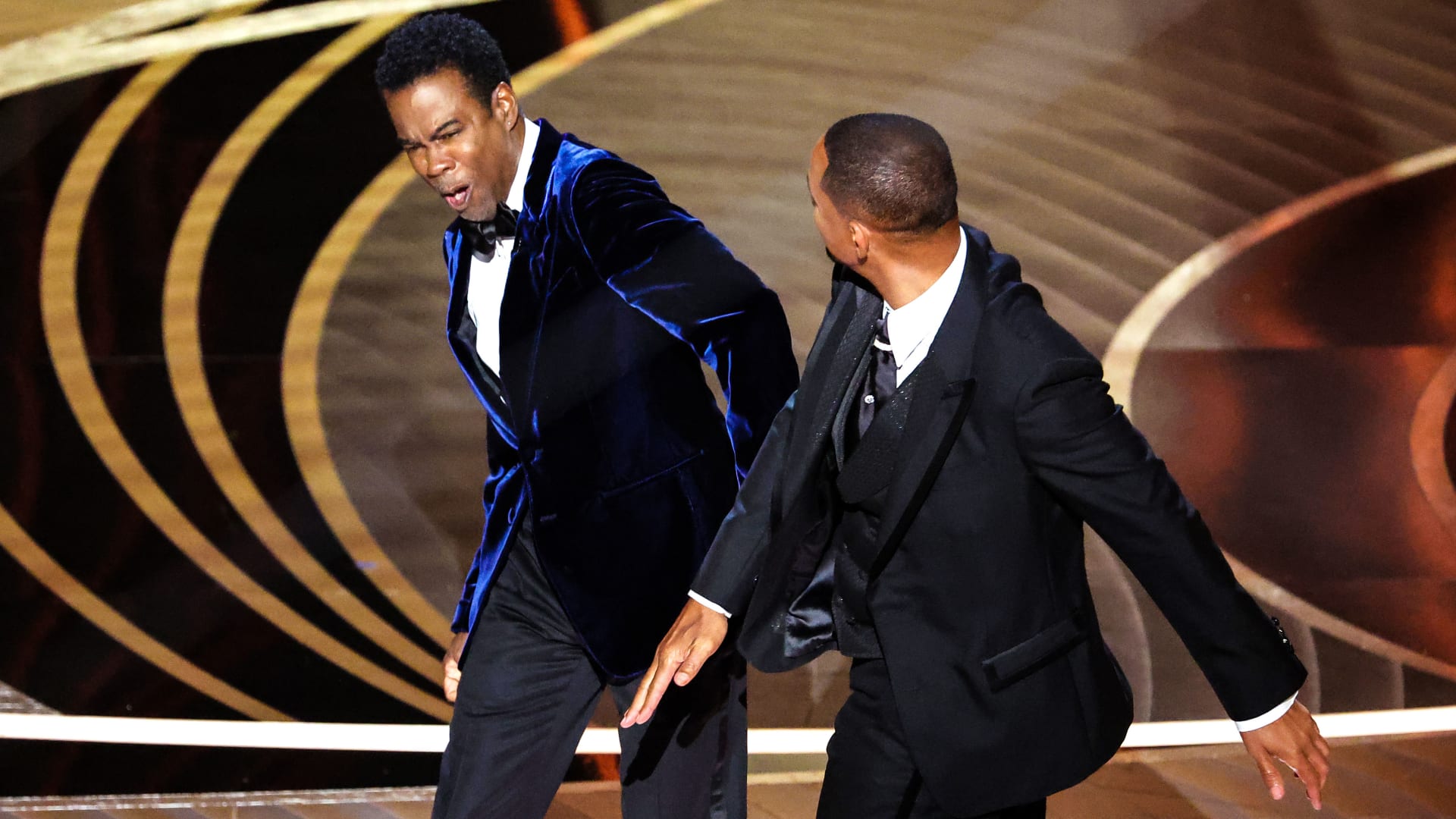 Will Smith slaps Chris Rock onstage during the show at the 94th Academy Awards.