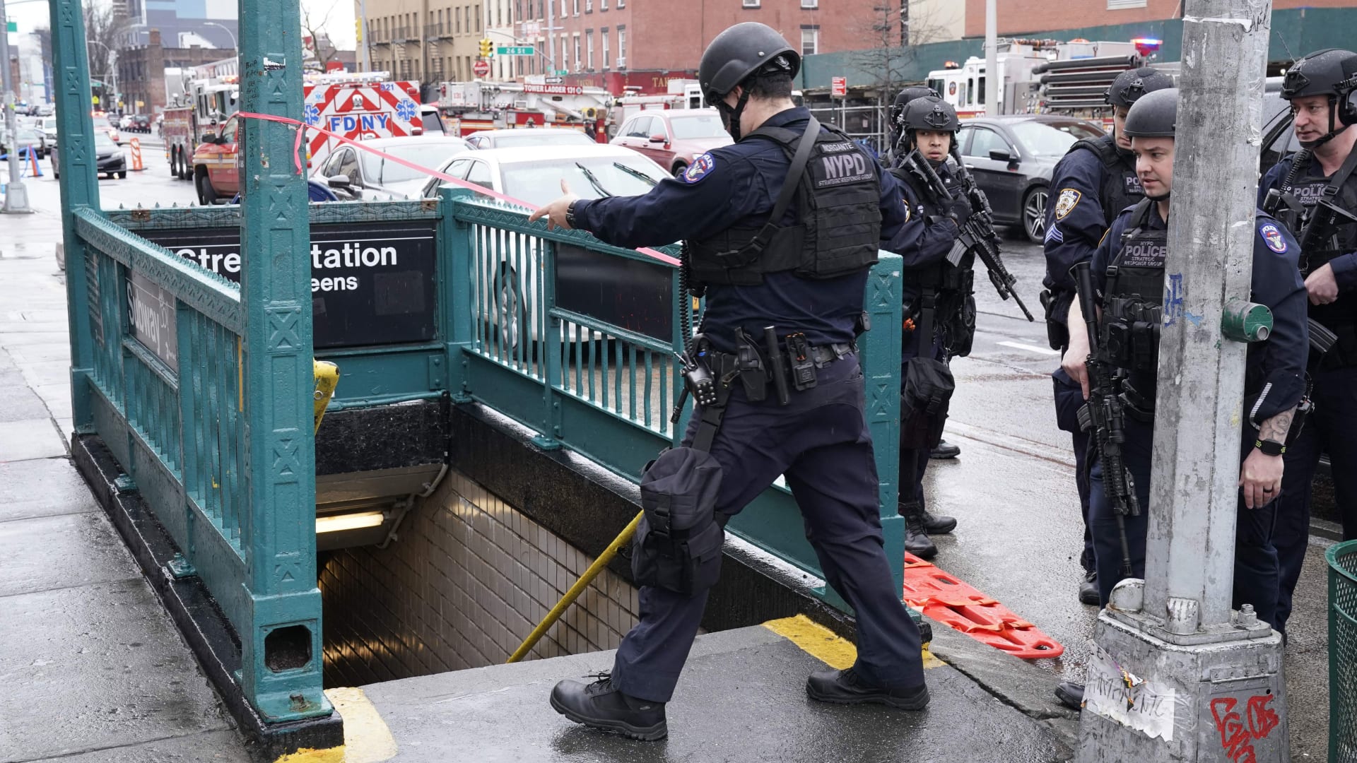 Members of the New York Police Department and emergency vehicles crowd the streets near a subway station in New York City on April 12, 2022, after at least 16 people were injured during a rush-hour shooting in Brooklyn.
