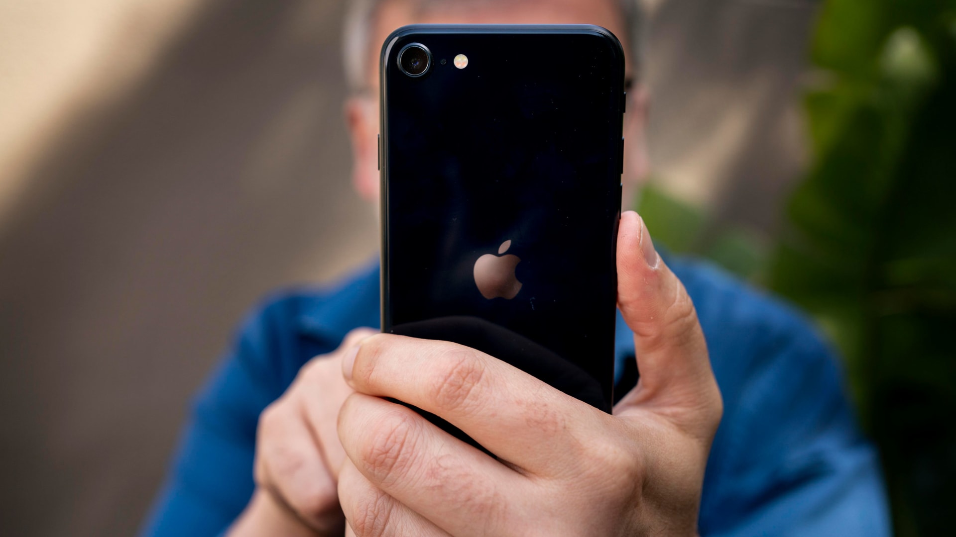A man uses an Apple iPhone. 