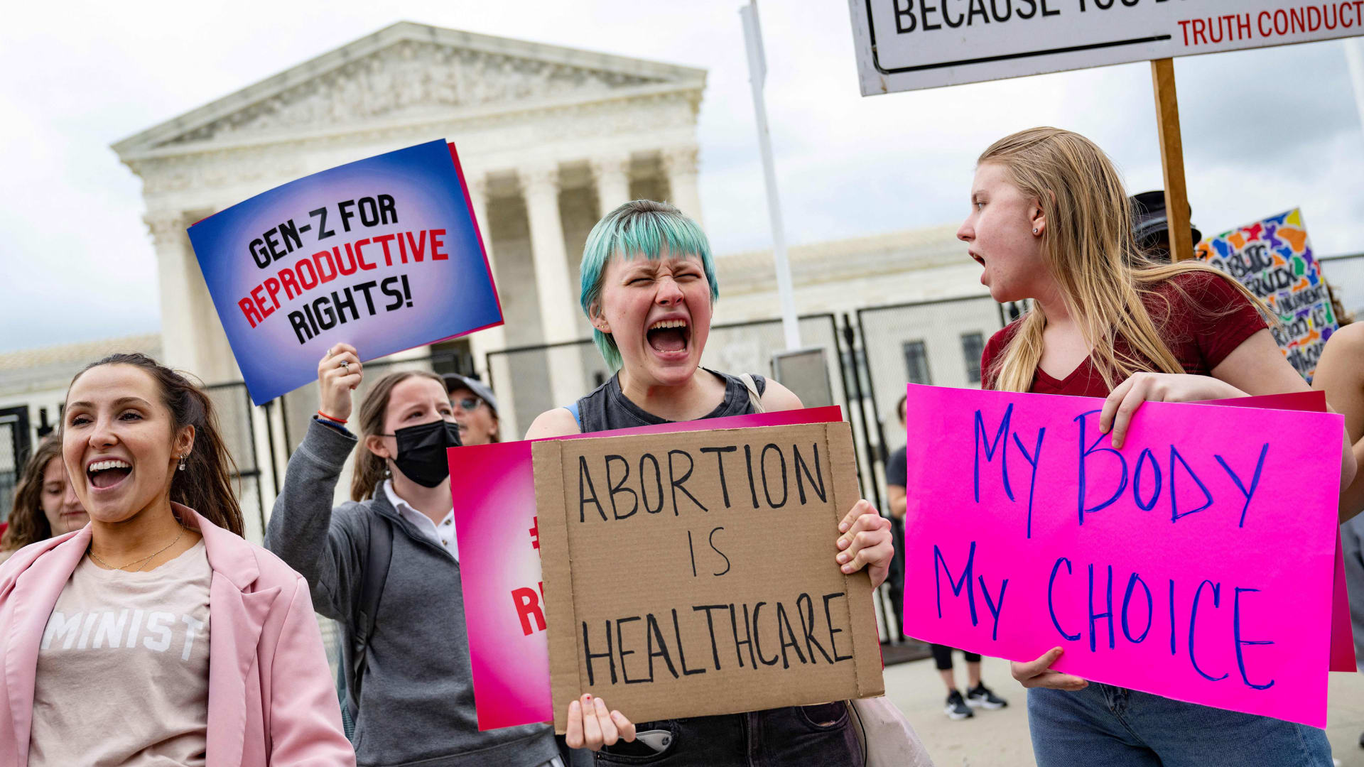 Pro-choice demonstrators chant in front of a fence that stands around the US Supreme Court in Washington, DC, on May 5, 2022.