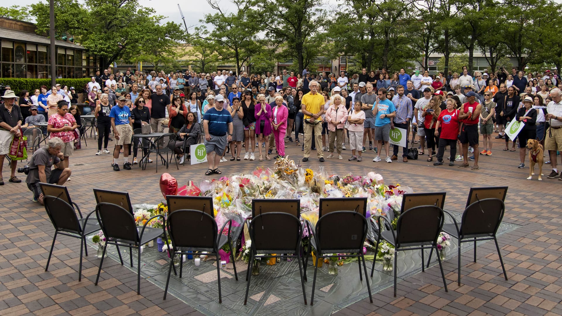 People gather in Port Clinton Square in Highland Park for several minutes of silence on Monday, July 11.