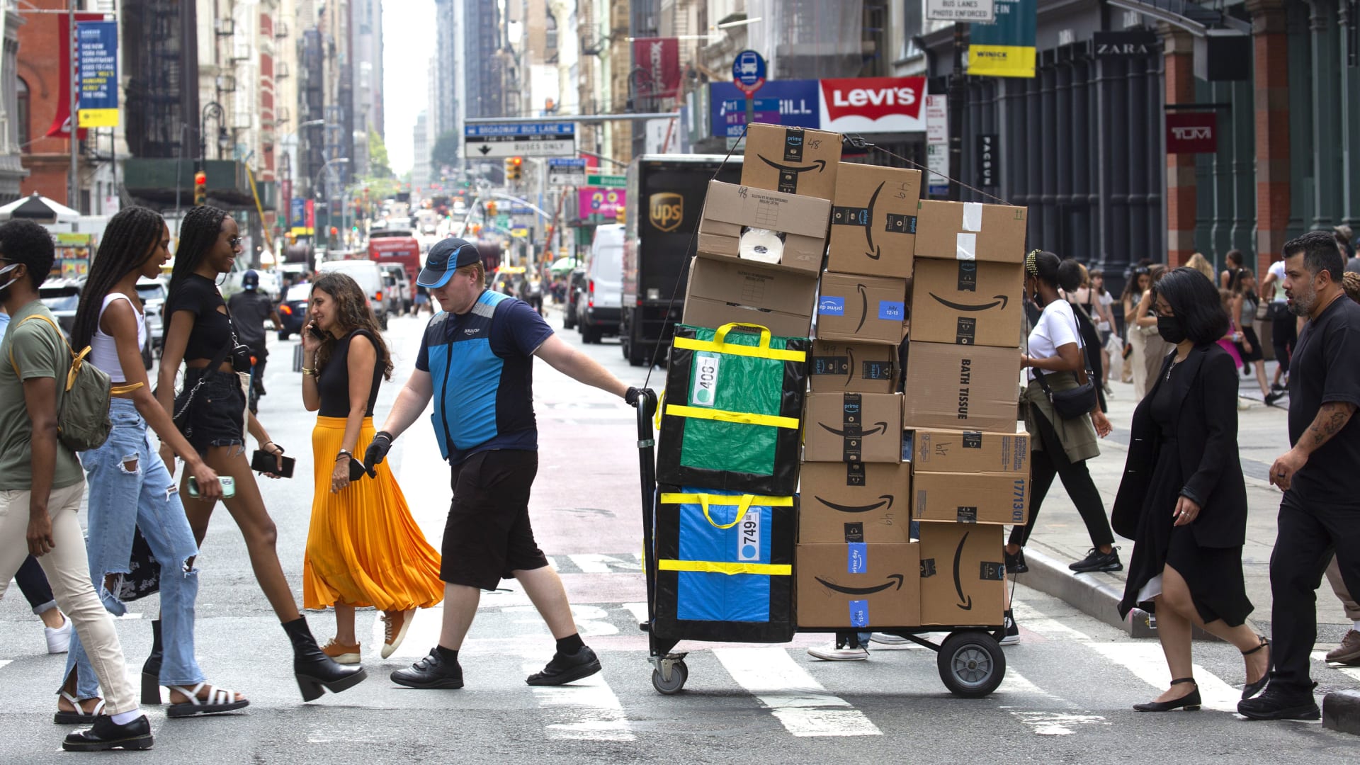 A worker delivers packages on Amazon Prime Day in New York, on Tuesday, July 12, 2022. 