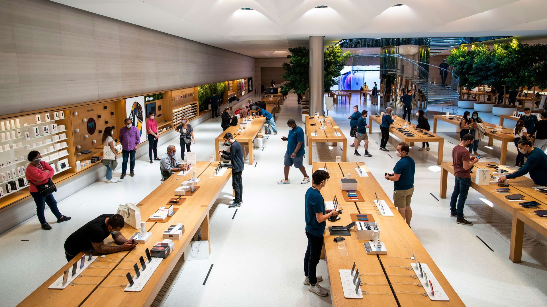 Customers shop at the flagship Apple store in NYC.