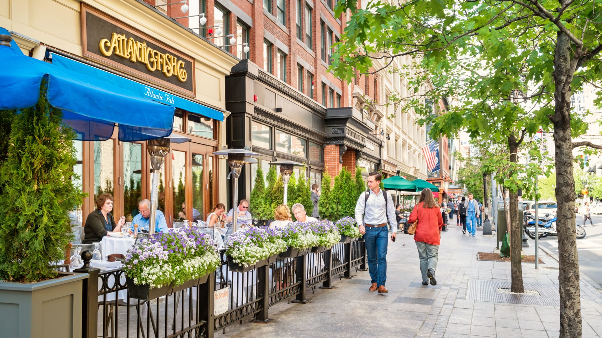 People dine at a restaurant patio in the Back Bay area of Boston.